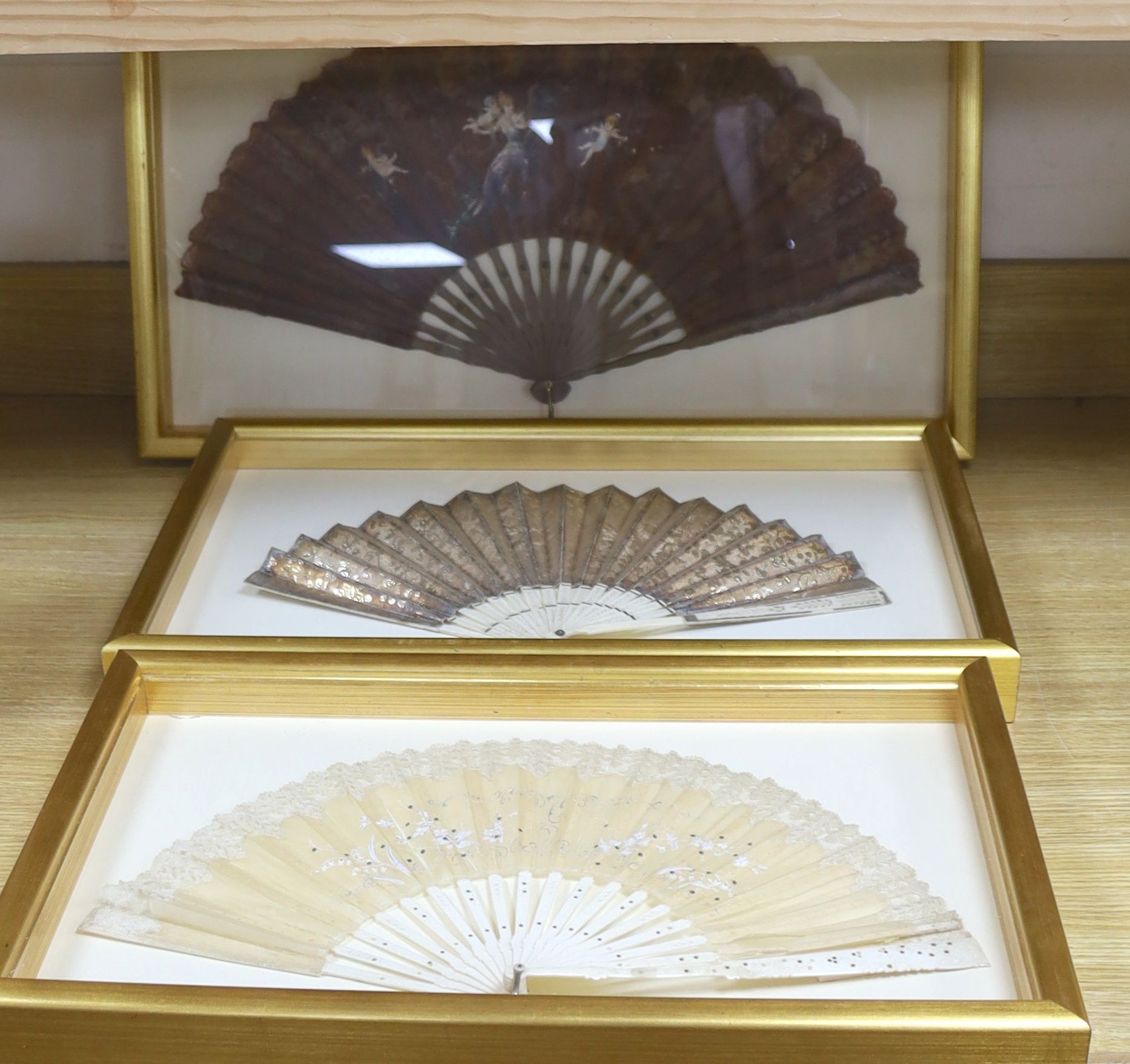 Two 19th century lace edged hand painted fans and a gilt and ivory fan, in 3 cases, largest case 42 x 67 cm